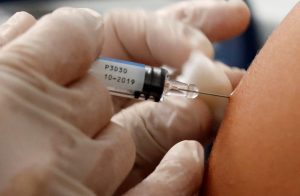 A doctor vaccinates a patient as part of the start of the seasonal influenza vaccination campaign in Nice