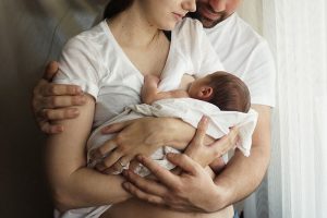 Father and mother with a newborn son. New multi-generation young family